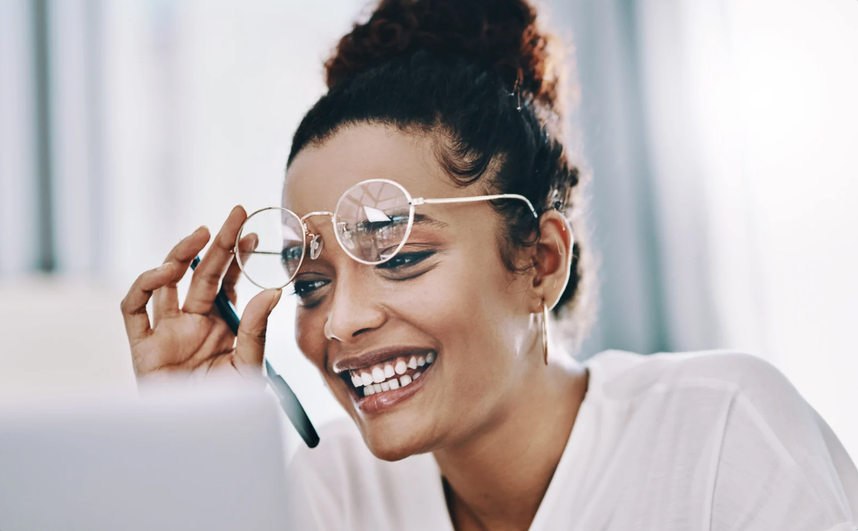 Woman with glasses looking at computer for Dynamic Vision Screening